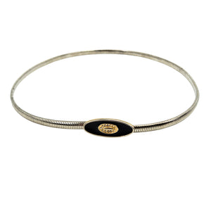 Silver-tone snake chain stretch skinny belt with black oval buckle and gold crest