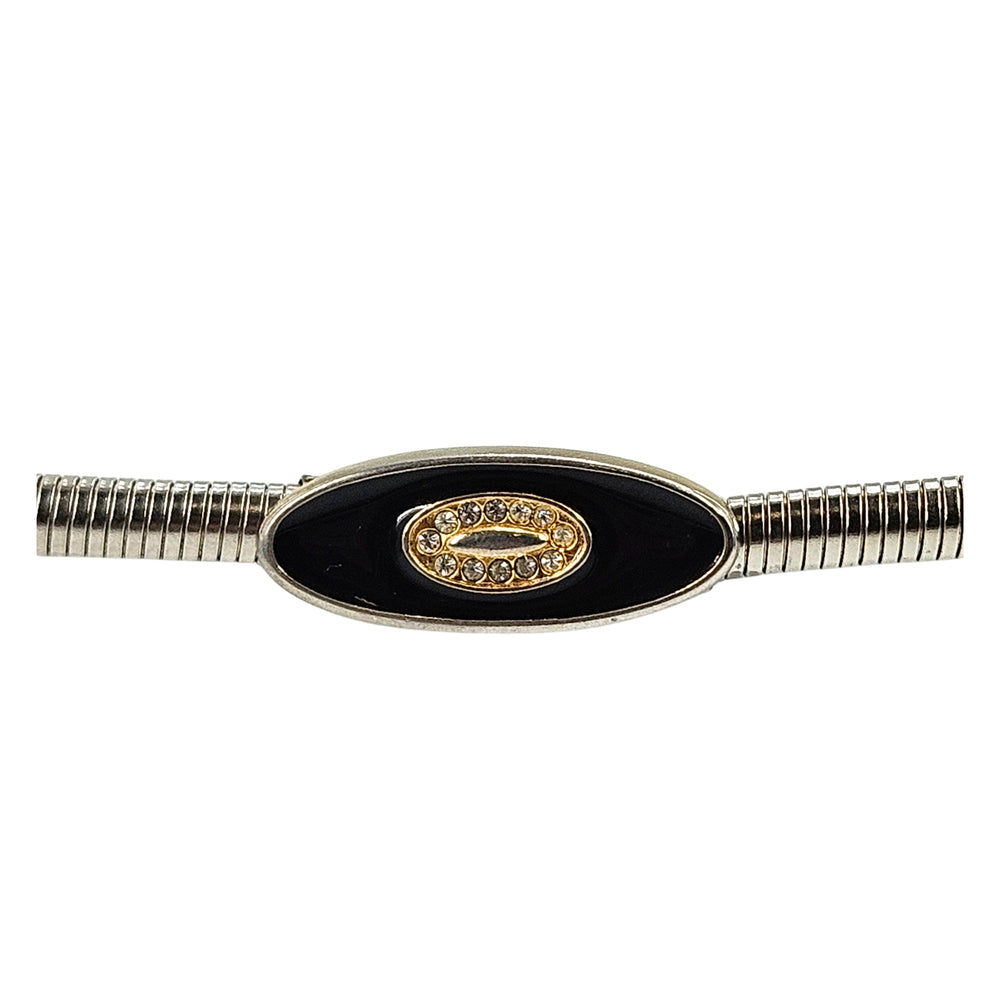 Silver-tone snake chain stretch skinny belt with black oval buckle and gold crest