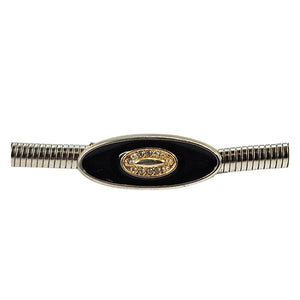 Silver-tone snake chain belt close-up: black oval buckle with gold crest centerpiece