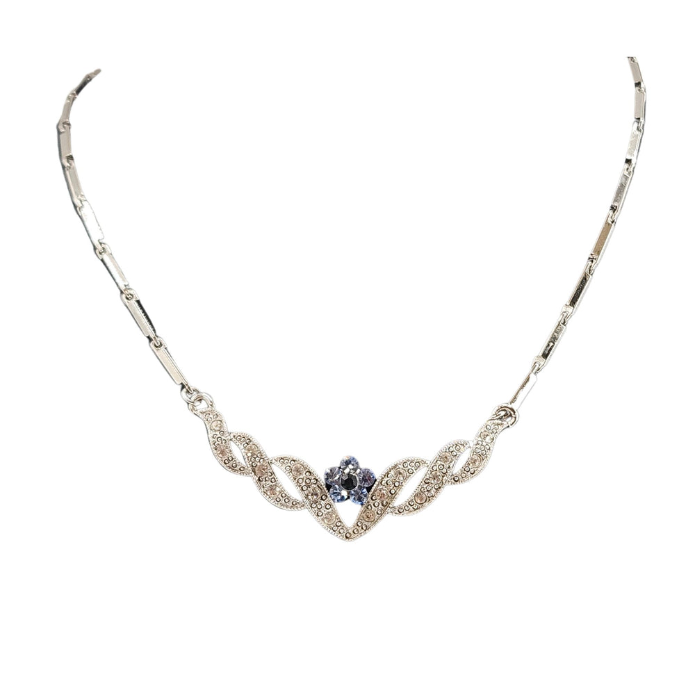 Silvertone rhinestone necklace with blue heart center and floral leaf motif links