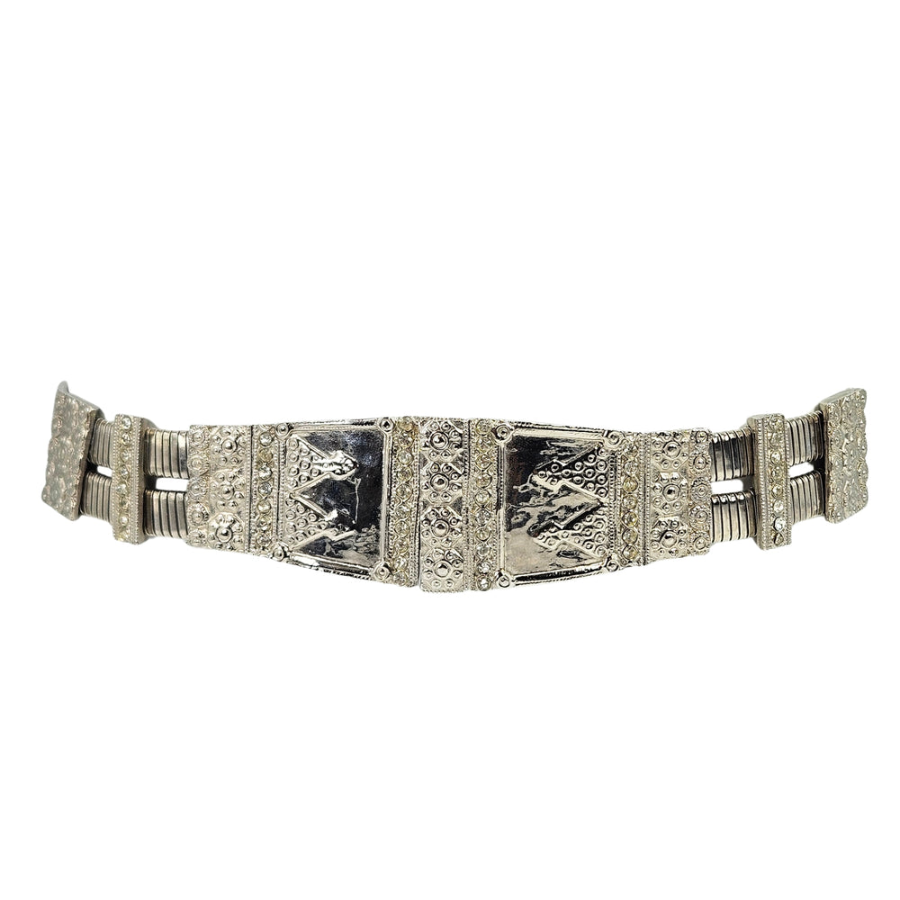 Silver stretch medium belt with ornate geometric panels and textured center plates