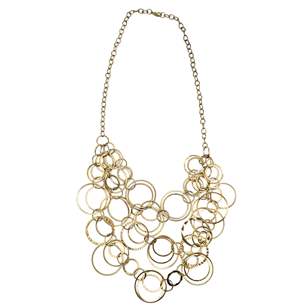 Gold circular bib necklace with layered ring links and chain collar.