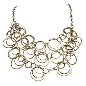 Gold statement bib necklace with layered circular rings and chain ends.
