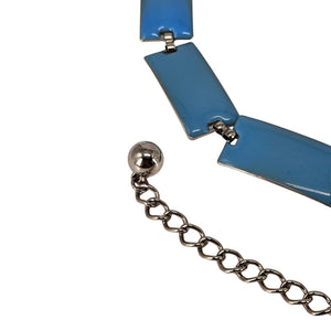Close-up of blue enamel chain belt links with silver-tone clasp and chain