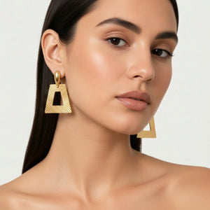 Goldtone geometric clip-on earrings with angular trapezoid dangles