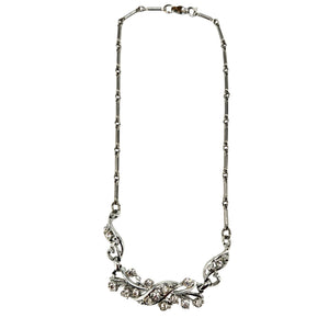 Rhinestone vine collar necklace with silver-tone chain and curved floral center setting.