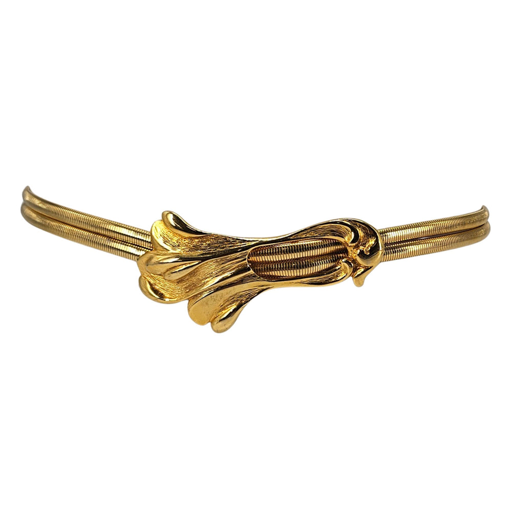 Gold stretch belt with snake-swirled metal buckle and ribbed flexible strap