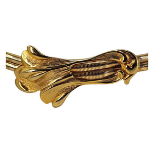 Gold snake buckle stretch belt with detailed swirl design and ribbed center