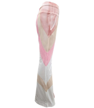 White flare sweatpants with pink and beige chevron-style paneling on the side.