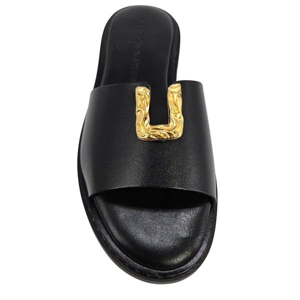 Black leather slide sandal with gold hammered U-shaped hardware on strap