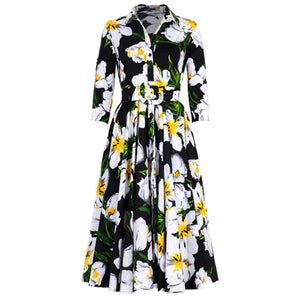 Floral midi dress with 3/4 sleeves, black background, yellow and white blooms, belt waist