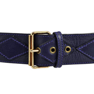 Close-up purple leather stud belt with gold buckle, eyelets, and diamond stitching
