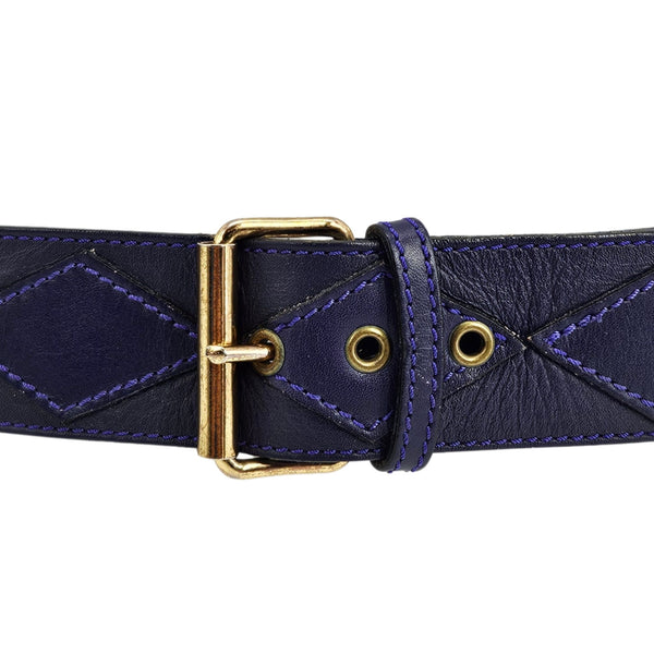 Close-up purple leather stud belt with gold buckle, eyelets, and diamond stitching