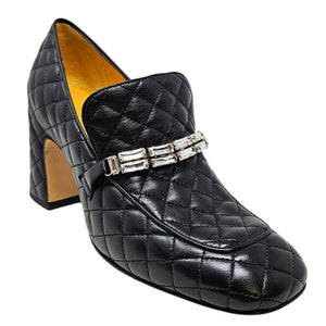 Black quilted loafer with square toe, block heel, and silver buckle