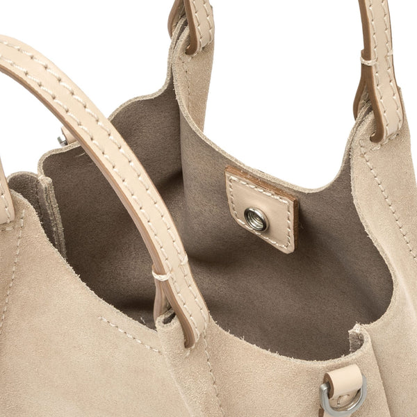 Interior view of nude mini hobo bag with suede lining and metal snap closure