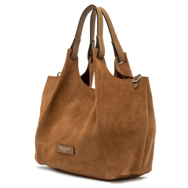 Caramel leather hobo bag side profile with two handles and small front logo patch