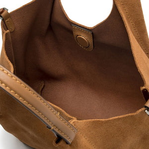 Caramel leather hobo bag interior view with snap pocket and stitched strap edge