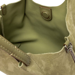 Mini hobo bag interior view with metal snap and smooth suede lining.