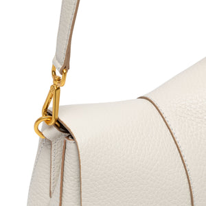 Off-white leather shoulder strap with gold chain hardware and secure attachment at bag