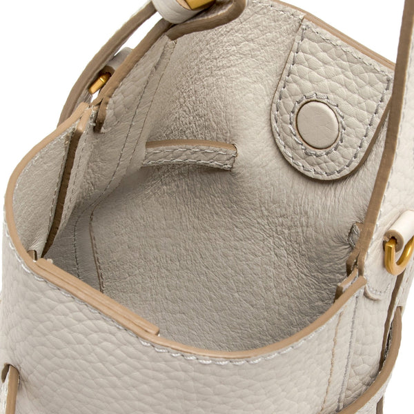 Off-white leather bucket bag interior view with zip pocket and drawstring opening