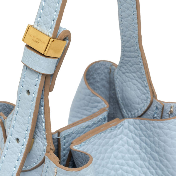Light blue leather bucket bag strap with gold buckle and drawcord ends