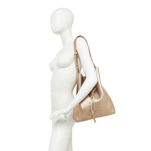 Light beige leather bucket bag on mannequin with short handles and drawstring