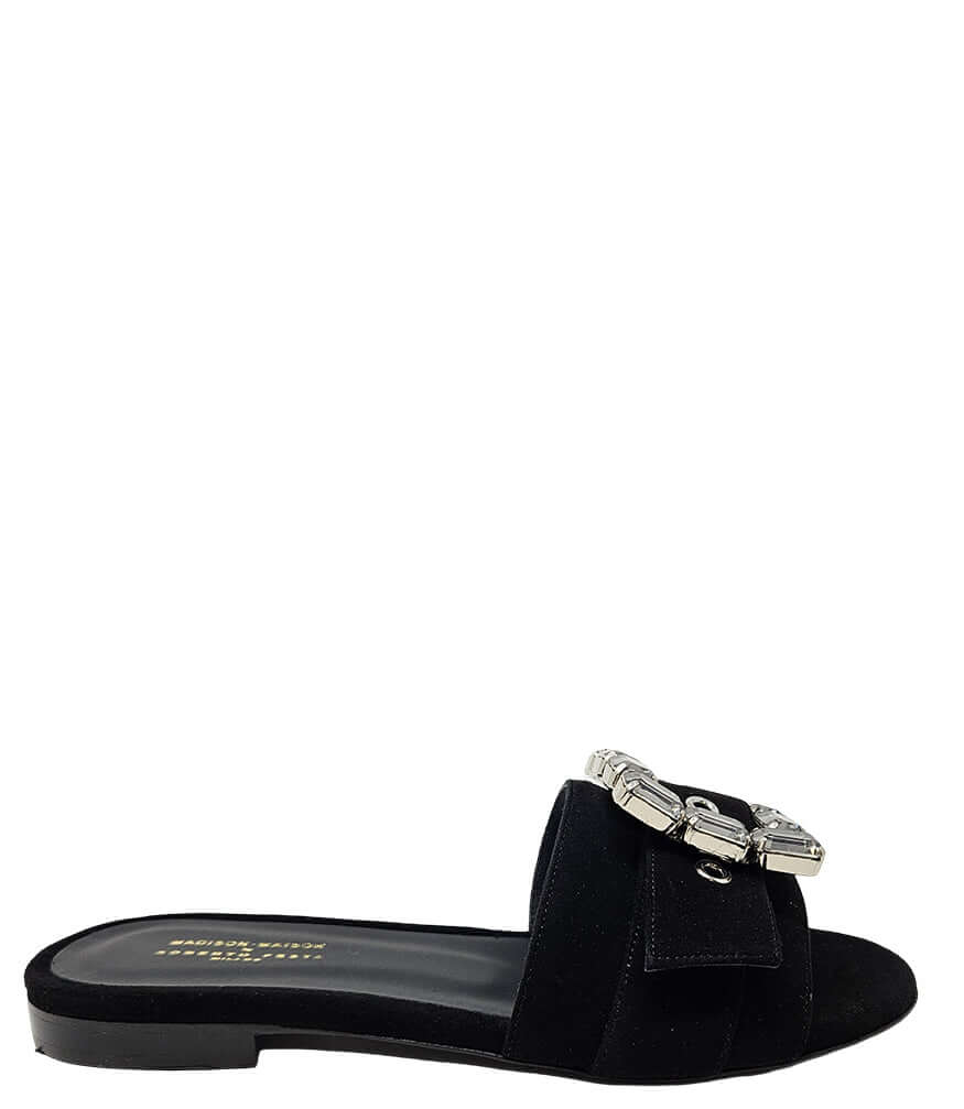 Black suede slide sandal with jeweled buckle and low rubber sole