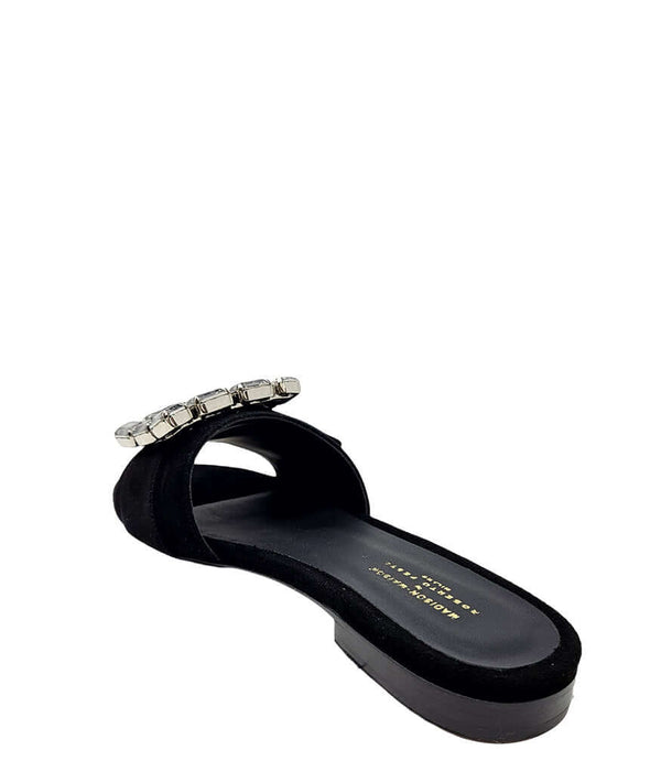 Black suede slide sandal with jeweled buckle strap and cushioned footbed