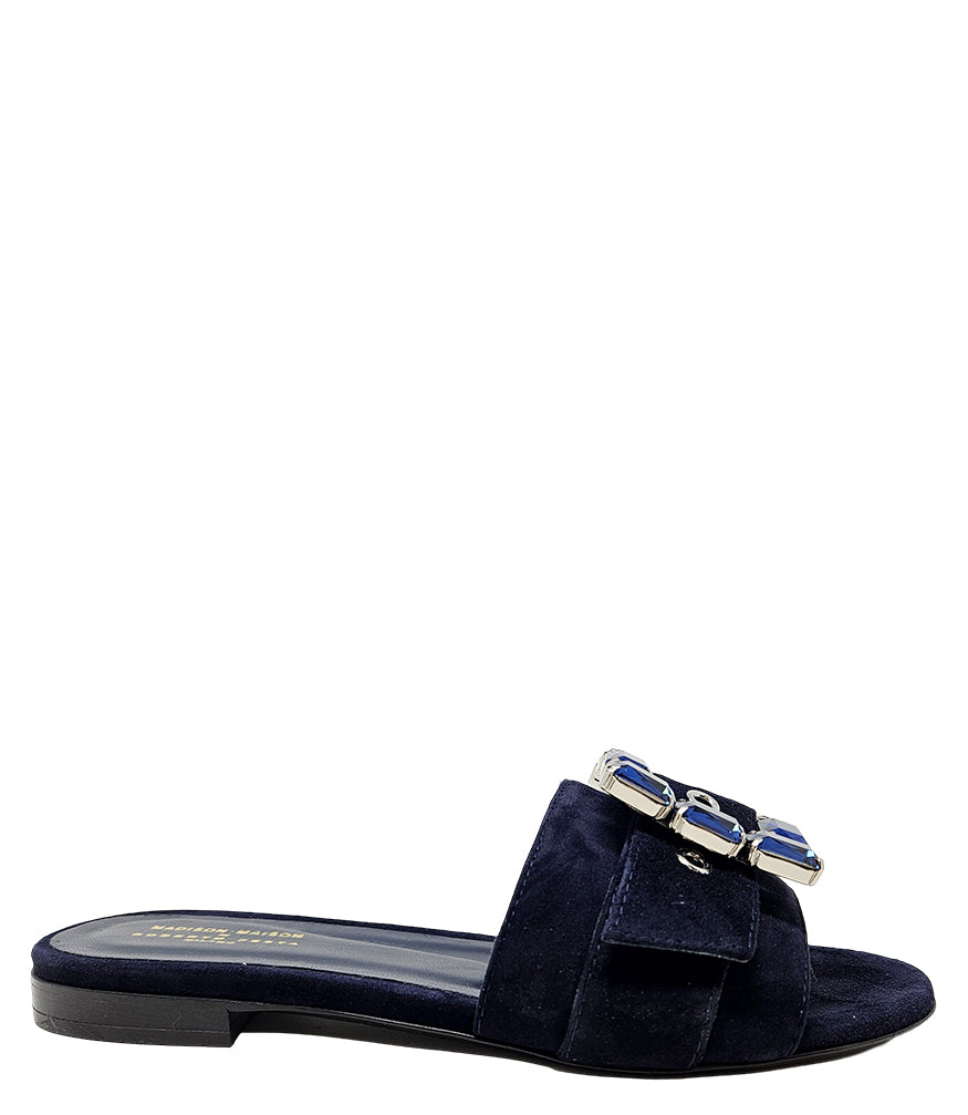 Navy suede slide sandal with jeweled buckle detail and low block heel