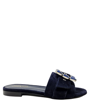 Navy suede slide sandal with jeweled buckle detail and low block heel