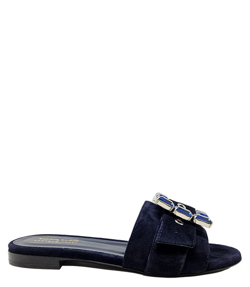 Navy suede slide sandal with jeweled buckle detail and low block heel