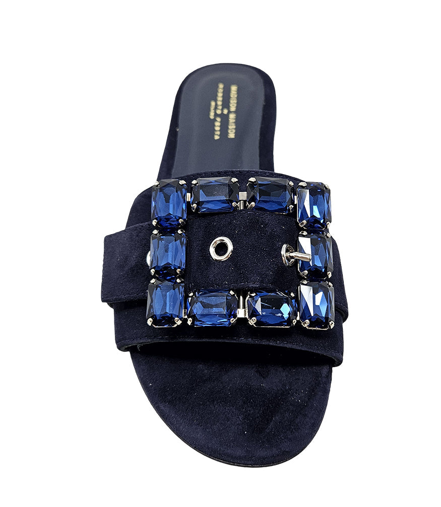 Navy suede slide sandal with jeweled buckle detail and low block heel
