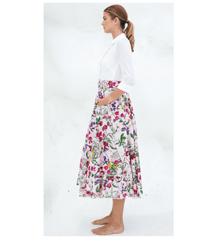 Floral midi skirt side view with gathered waist and full pleats on light nude base