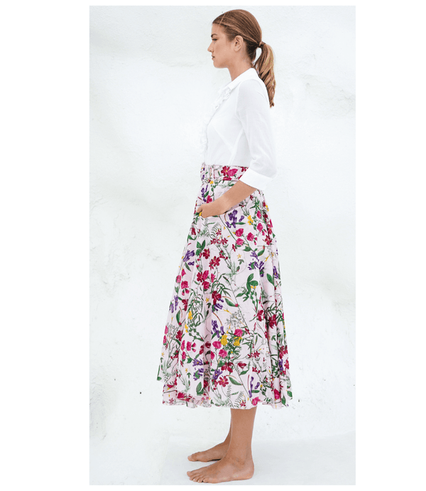 Floral midi skirt side view with gathered waist and full pleats on light nude base