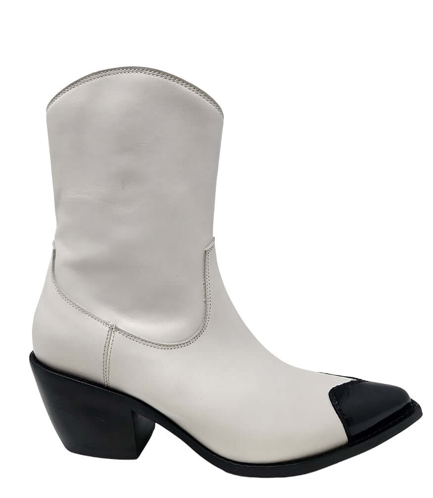 White ankle boot with glossy black heart-shaped toe and chunky black heel
