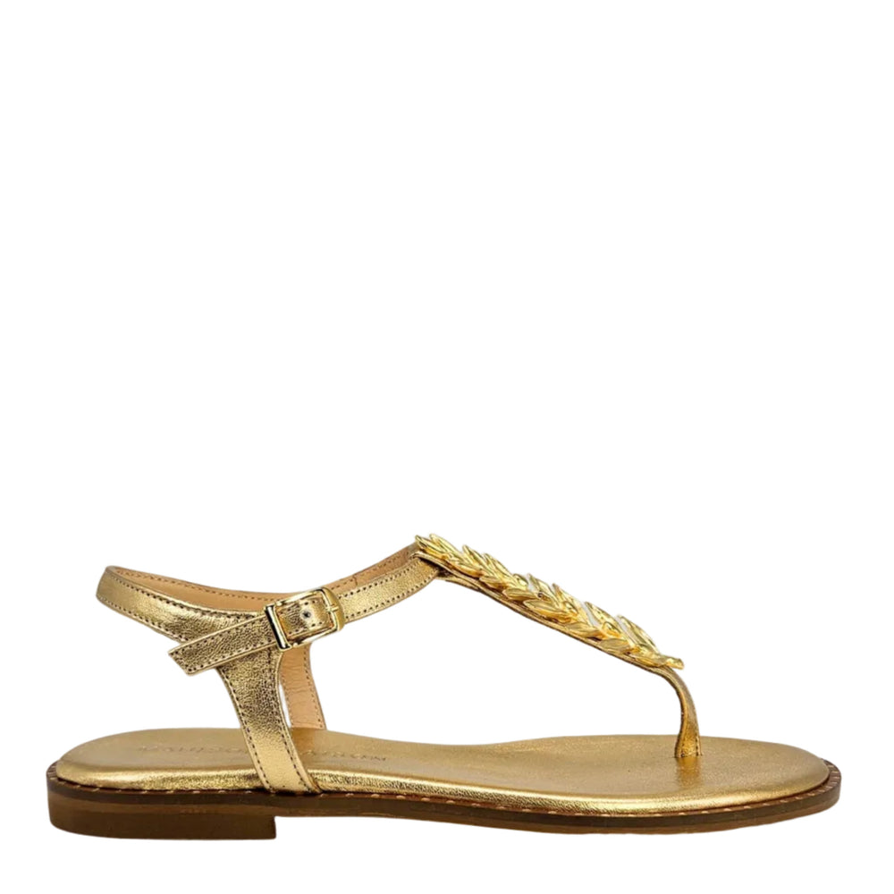 Gold thong sandal with flat sole, T-strap and leaf ornament at toe
