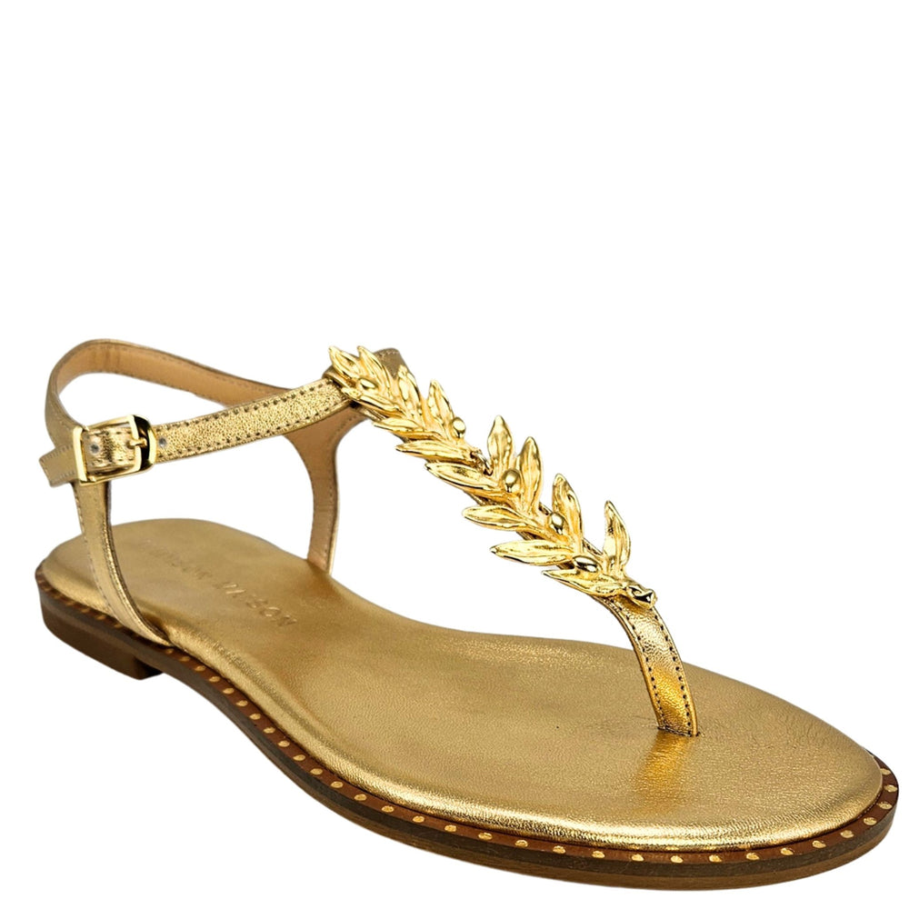 Gold thong sandal with flat sole, T-strap and leaf ornament at toe
