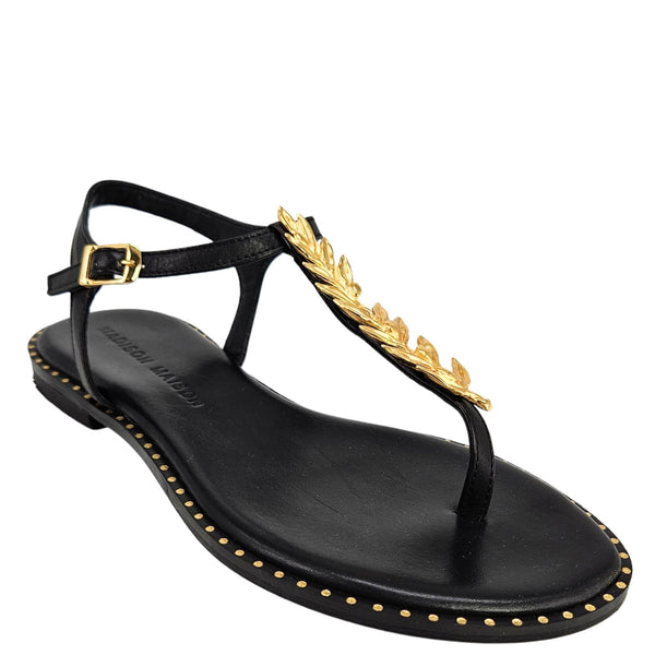 Black leather thong sandal with gold leaf ornament, ankle strap buckle, studded edge