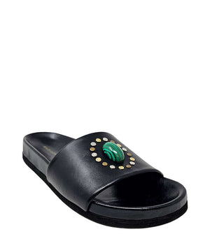 Black open-toe slide sandal with green oval gem and gold stud accents