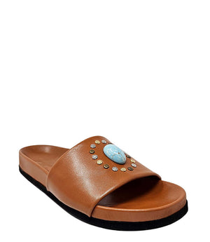 Cognac open-toe slide sandal with embellished blue oval medallion on strap