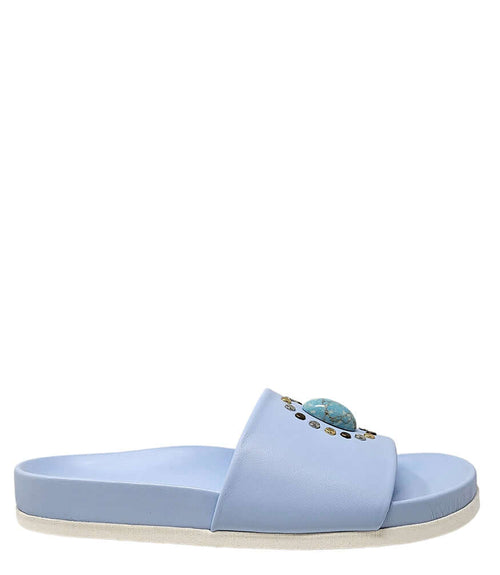 Sky blue open-toe slide sandal with oval jewel and gold stud accents, flat sole