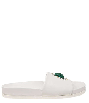White open-toe slide sandal with green oval ornament and gold stud accents
