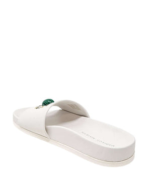 White open-toe slide sandal with padded strap and cushioned sole, green ornament