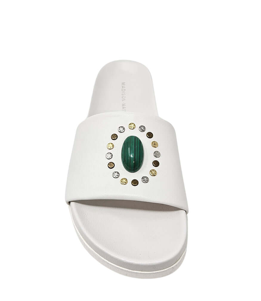White open-toe slide sandal with green oval ornament and gold stud accents