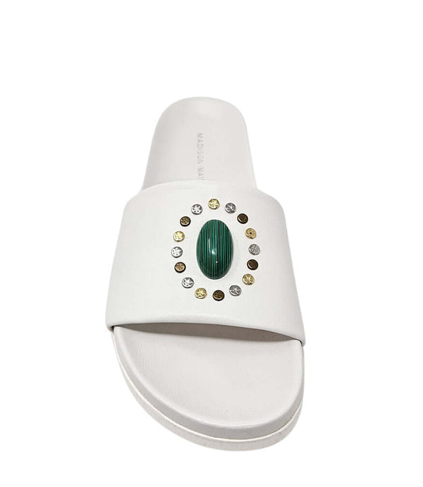 White open-toe slide sandal, front view, green oval gem with gold stud circle