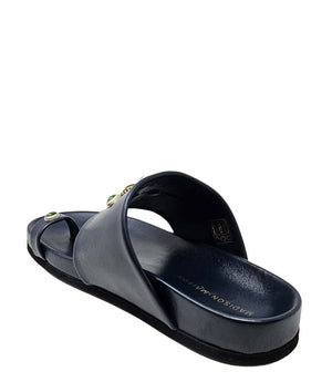 Navy slide sandal showing footbed and toe ring strap with green ornament