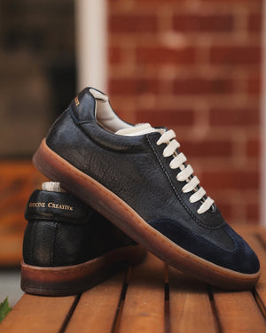 Chance/101 black leather lace-up sneaker, back and side view with cream laces and gum sole