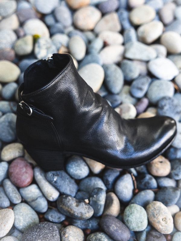 Black leather ankle boot with low heel and side pull tabs