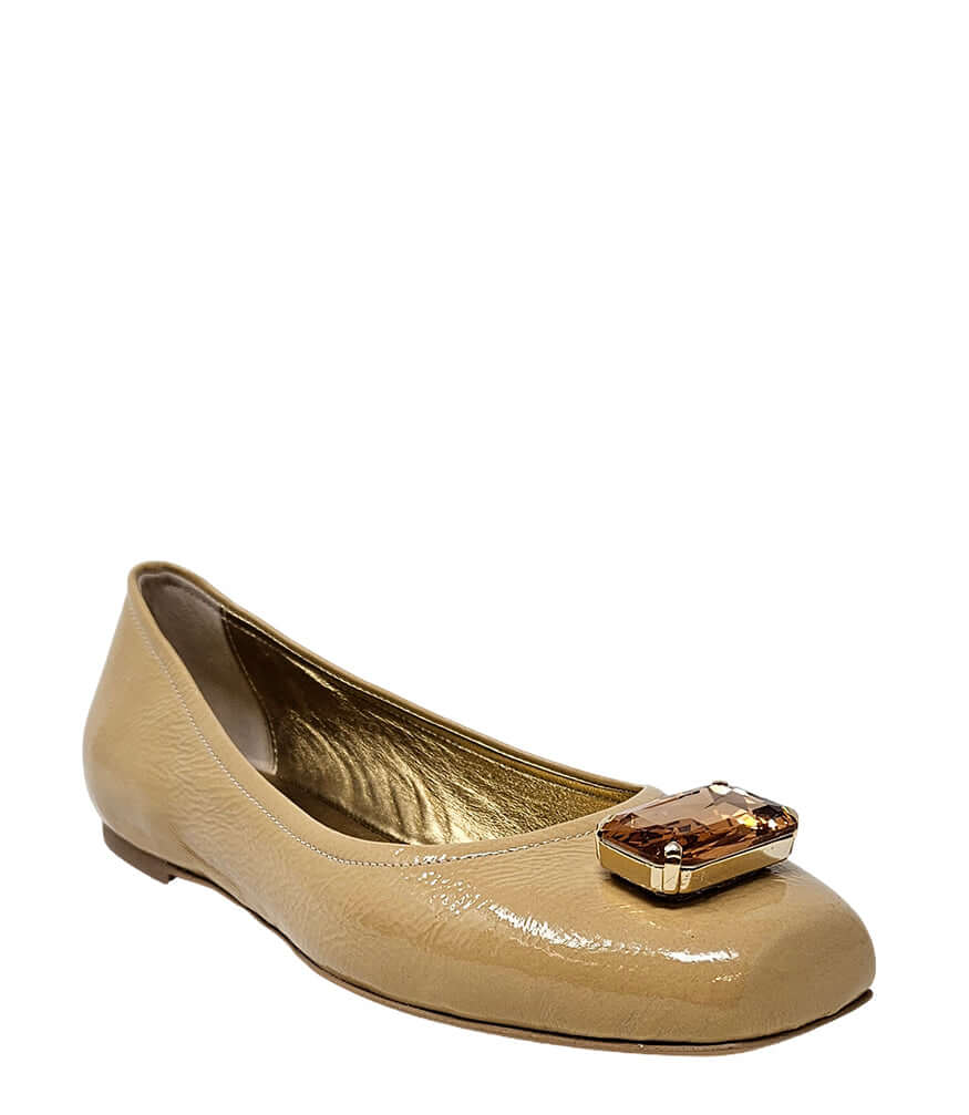Beige patent ballet flats with rounded toe and jeweled buckle at vamp