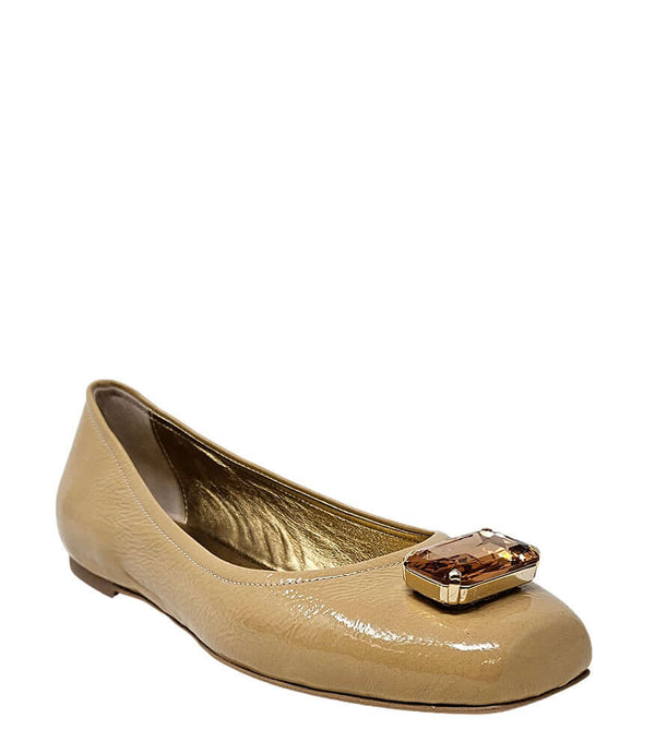 Beige ballet flats with rounded toe, low sole, and jeweled buckle at front